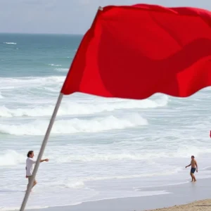 Hazardous beach conditions with red flags indicating danger