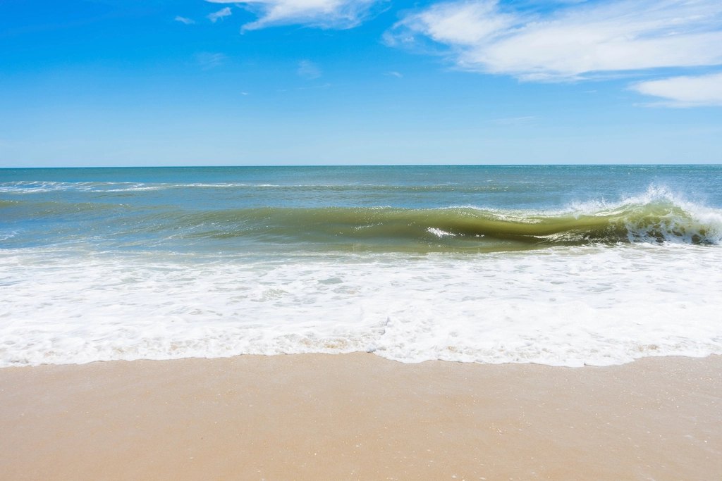 Wooden beach houses along a sandy shoreline